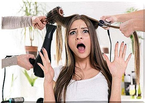 Woman with hair straightener and hair dryer