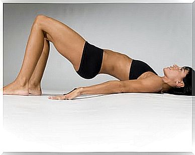 Woman lies on her back with hips up