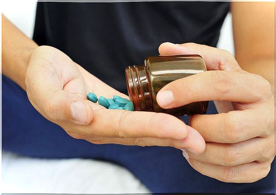 Hand with blue pills