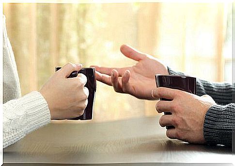 Two people talking while enjoying a cup of coffee