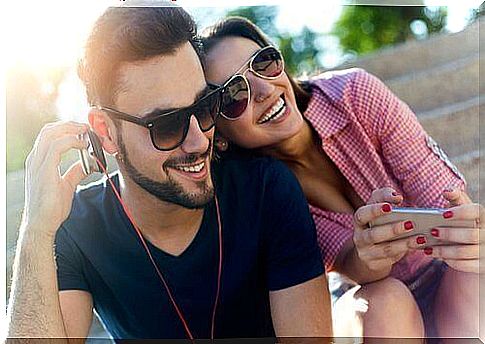 Smiling man and woman listening music