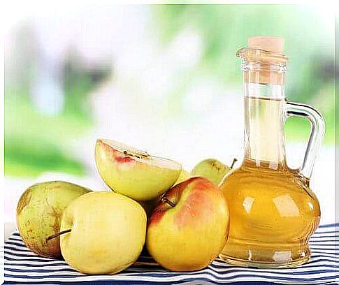 Bottle of apple cider vinegar with apples