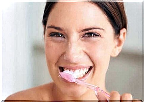 Woman is brushing her teeth