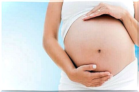 Woman holding her pregnant belly