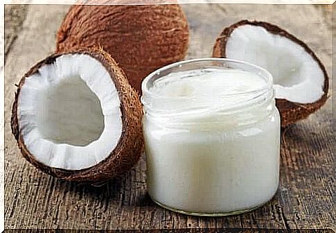 A jar of coconut oil and fresh coconuts