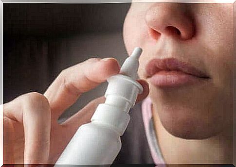 A woman using a saline nasal spray